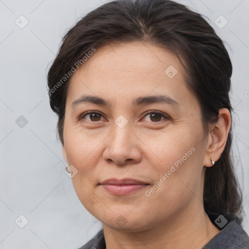 Joyful white adult female with medium  brown hair and brown eyes