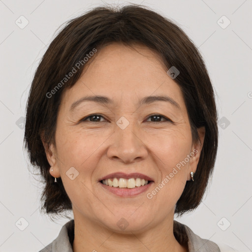 Joyful white adult female with medium  brown hair and brown eyes