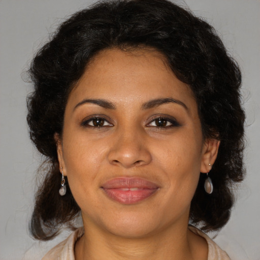 Joyful black young-adult female with medium  brown hair and brown eyes
