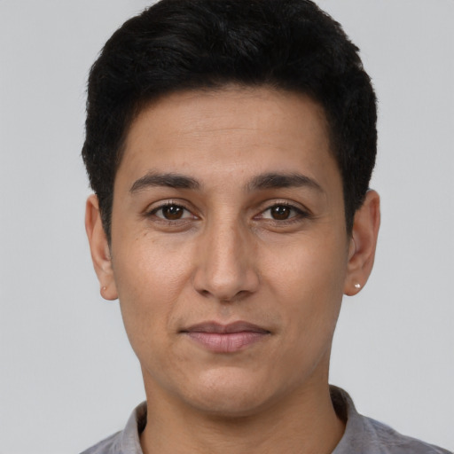 Joyful latino young-adult male with short  black hair and brown eyes
