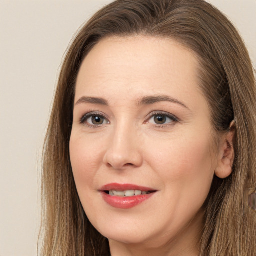 Joyful white young-adult female with long  brown hair and brown eyes