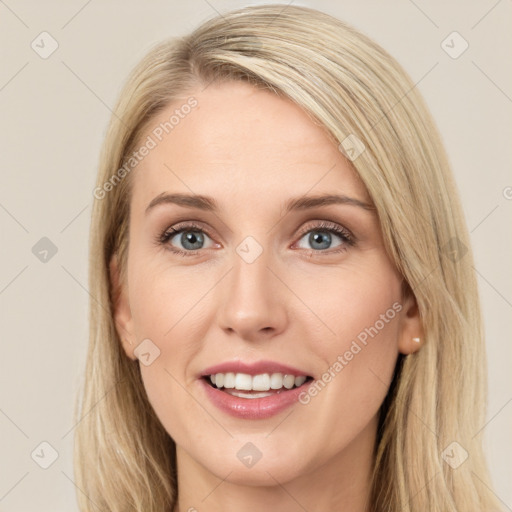 Joyful white young-adult female with long  brown hair and blue eyes