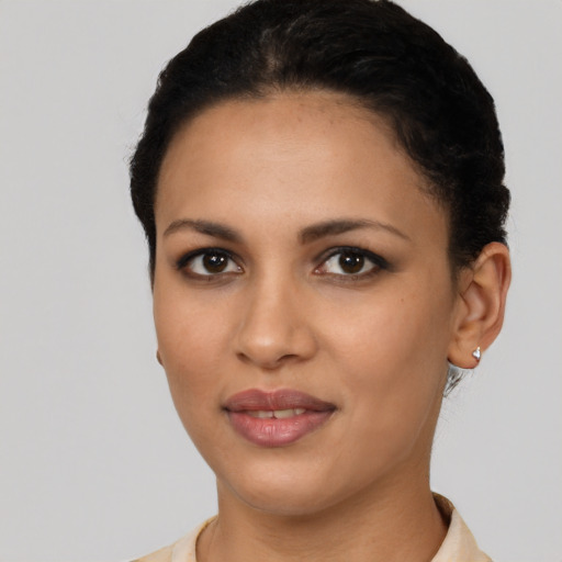 Joyful latino young-adult female with short  black hair and brown eyes