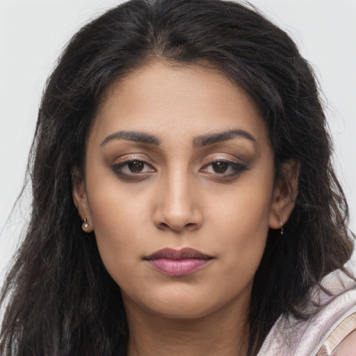 Joyful latino young-adult female with long  brown hair and brown eyes