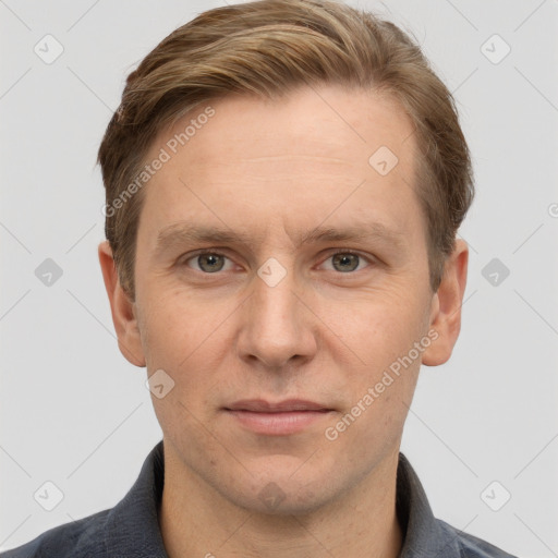 Joyful white adult male with short  brown hair and grey eyes