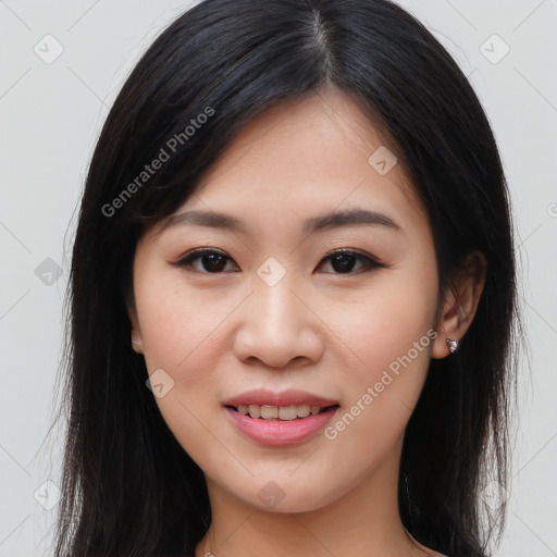 Joyful asian young-adult female with long  brown hair and brown eyes