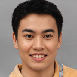 Joyful asian young-adult male with short  brown hair and brown eyes