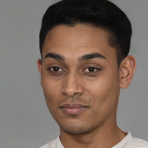 Joyful latino young-adult male with short  black hair and brown eyes