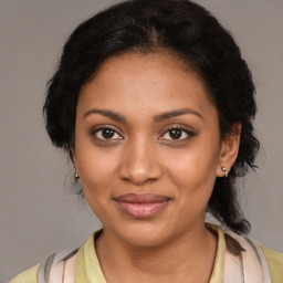 Joyful black young-adult female with medium  brown hair and brown eyes