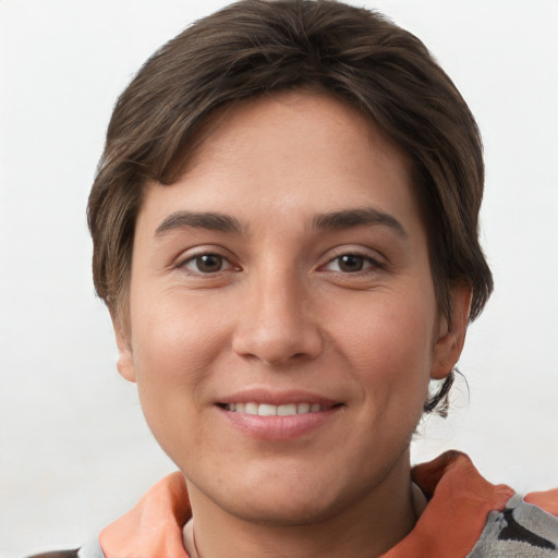 Joyful white young-adult female with short  brown hair and grey eyes