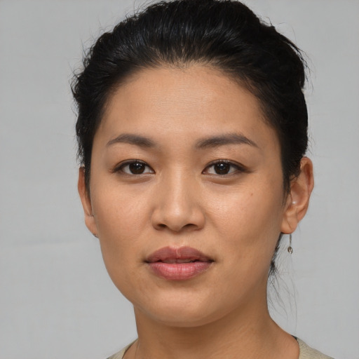 Joyful asian young-adult female with short  black hair and brown eyes