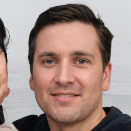 Joyful white adult male with short  brown hair and brown eyes