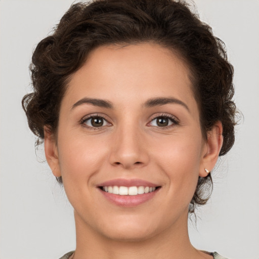 Joyful white young-adult female with medium  brown hair and brown eyes