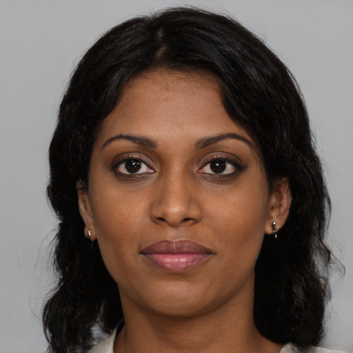 Joyful black young-adult female with medium  brown hair and brown eyes
