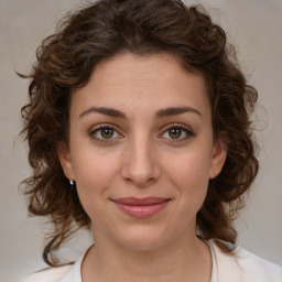 Joyful white young-adult female with medium  brown hair and green eyes