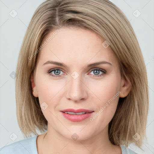 Joyful white young-adult female with medium  brown hair and blue eyes