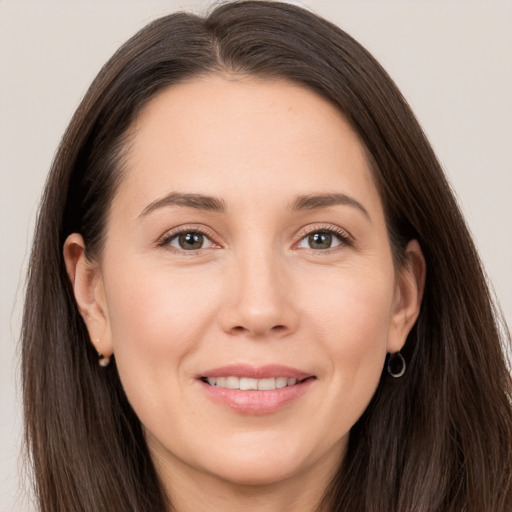 Joyful white young-adult female with long  brown hair and brown eyes