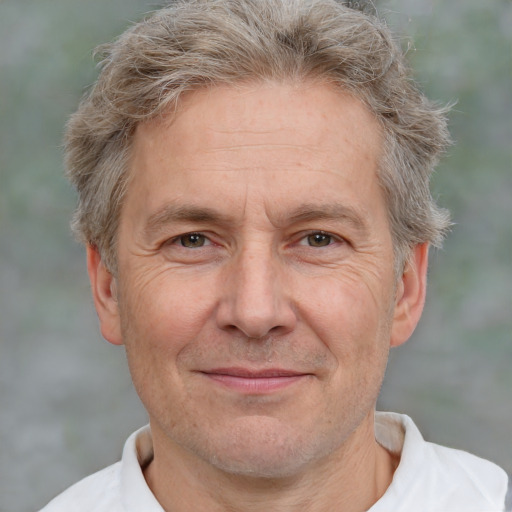 Joyful white middle-aged male with short  brown hair and brown eyes