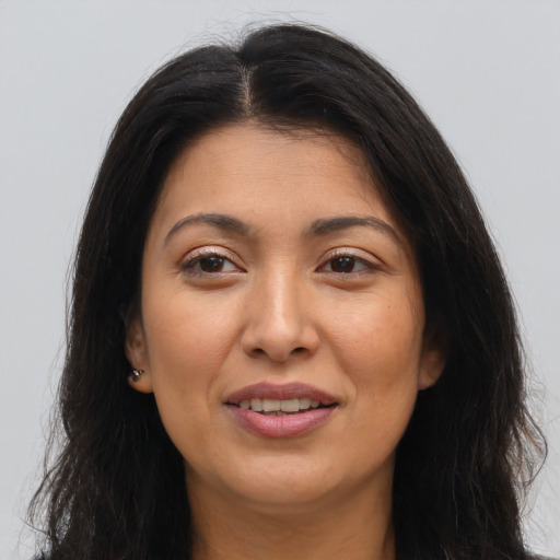 Joyful latino young-adult female with long  brown hair and brown eyes
