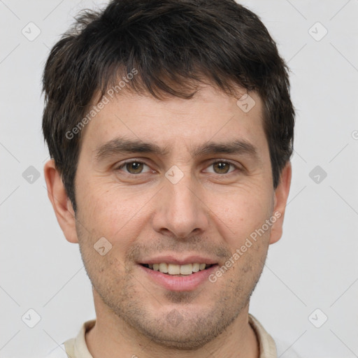 Joyful white adult male with short  brown hair and brown eyes