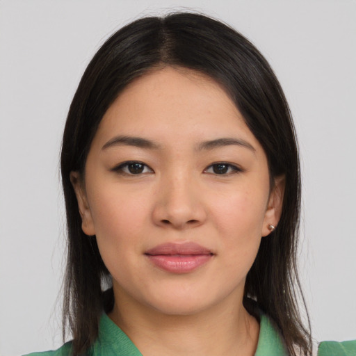Joyful asian young-adult female with long  black hair and brown eyes