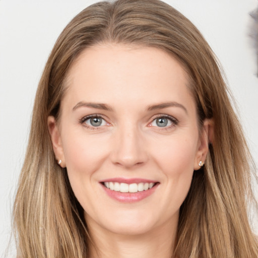 Joyful white young-adult female with long  brown hair and green eyes