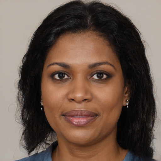 Joyful black young-adult female with medium  brown hair and brown eyes
