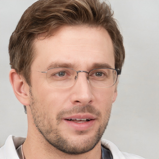 Joyful white adult male with short  brown hair and grey eyes