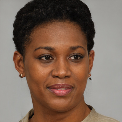Joyful black young-adult female with short  black hair and brown eyes