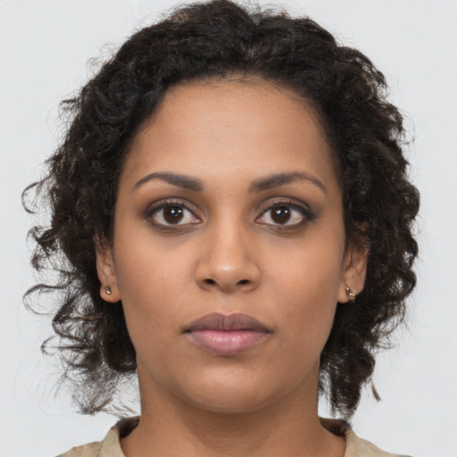 Neutral black young-adult female with long  brown hair and brown eyes