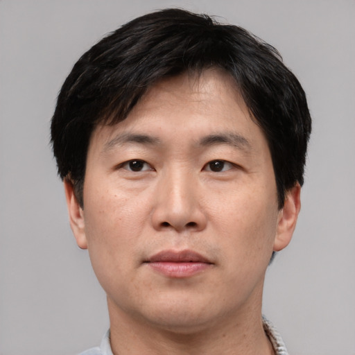 Neutral asian adult male with short  brown hair and brown eyes