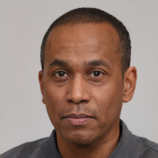 Neutral latino adult male with short  black hair and brown eyes