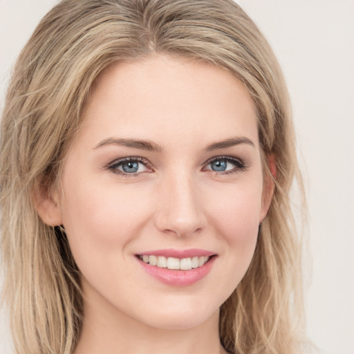 Joyful white young-adult female with long  brown hair and green eyes