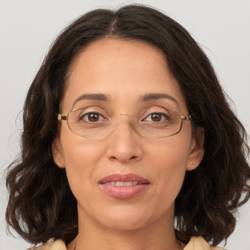 Joyful white adult female with long  brown hair and brown eyes