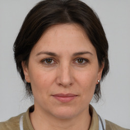 Joyful white adult female with medium  brown hair and brown eyes