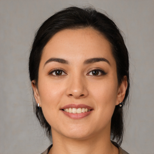 Joyful latino young-adult female with medium  brown hair and brown eyes