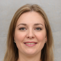 Joyful white young-adult female with long  brown hair and green eyes