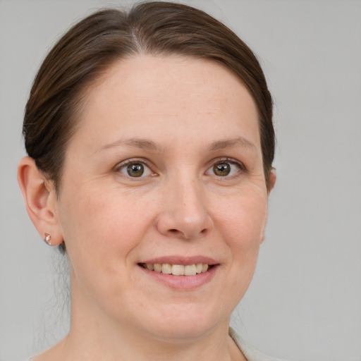 Joyful white adult female with medium  brown hair and grey eyes