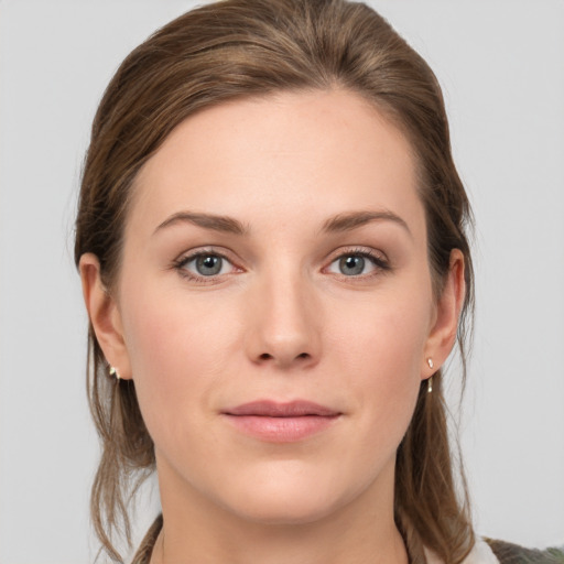 Joyful white young-adult female with medium  brown hair and grey eyes