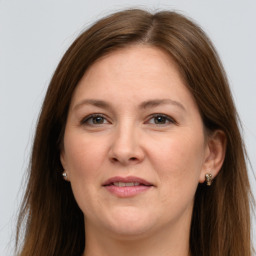 Joyful white adult female with long  brown hair and grey eyes