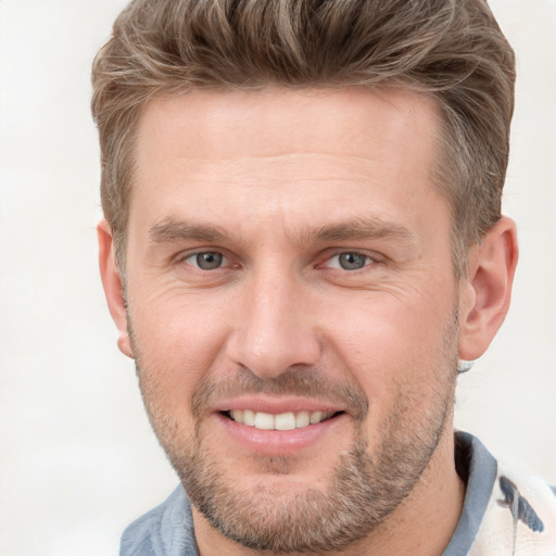 Joyful white adult male with short  brown hair and brown eyes