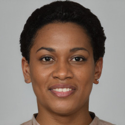 Joyful black young-adult female with short  brown hair and brown eyes
