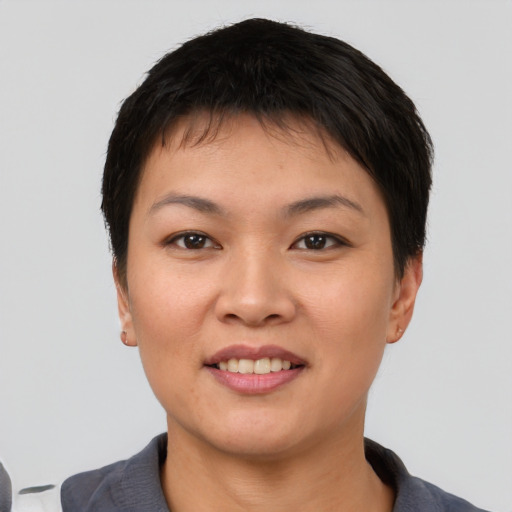 Joyful asian young-adult female with short  brown hair and brown eyes