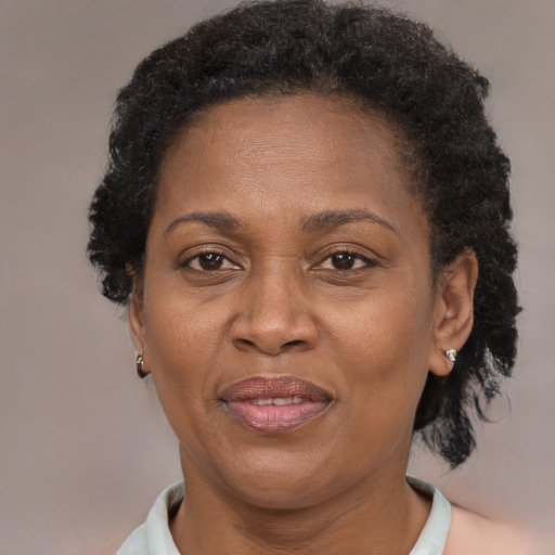 Joyful black adult female with short  brown hair and brown eyes