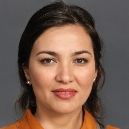 Joyful white young-adult female with medium  brown hair and brown eyes