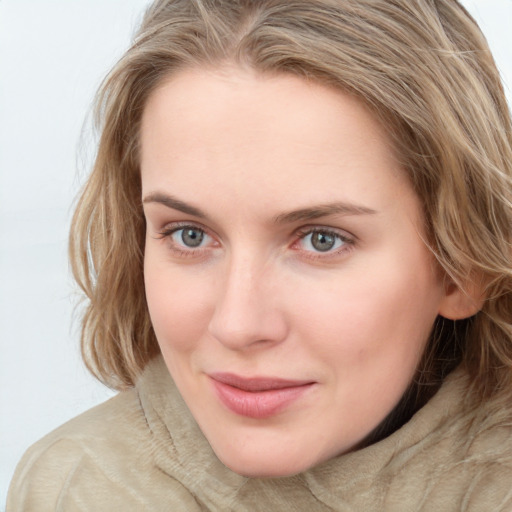 Joyful white young-adult female with long  brown hair and blue eyes