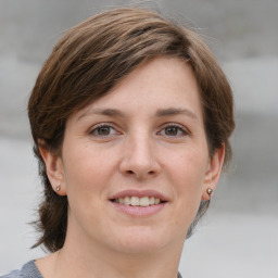 Joyful white young-adult female with medium  brown hair and grey eyes