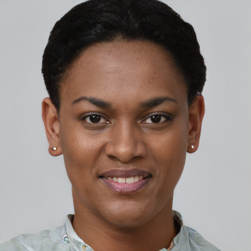 Joyful black young-adult female with short  black hair and brown eyes