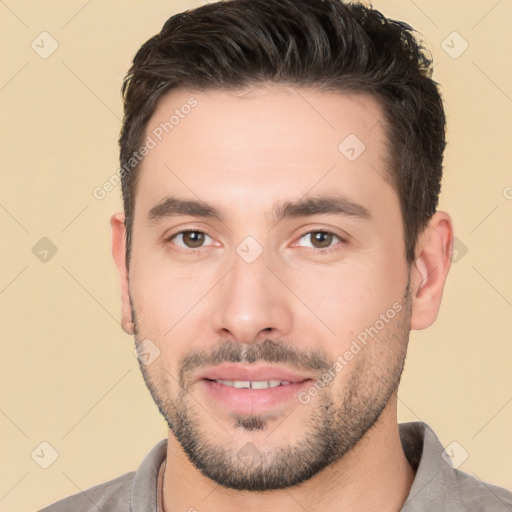 Joyful white young-adult male with short  black hair and brown eyes