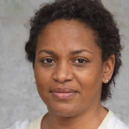 Joyful black adult female with short  brown hair and brown eyes